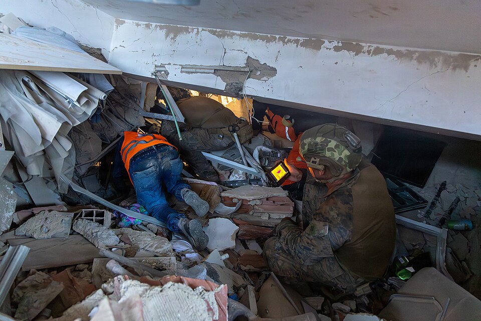 Search and rescue teams working through the rubble